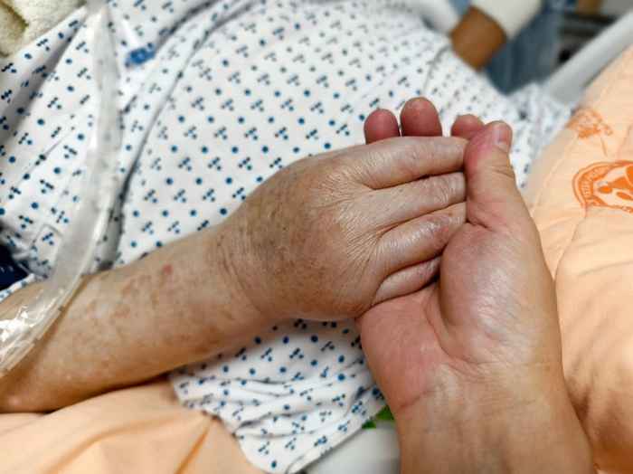 Family supporting elderly parent during pilgrimage