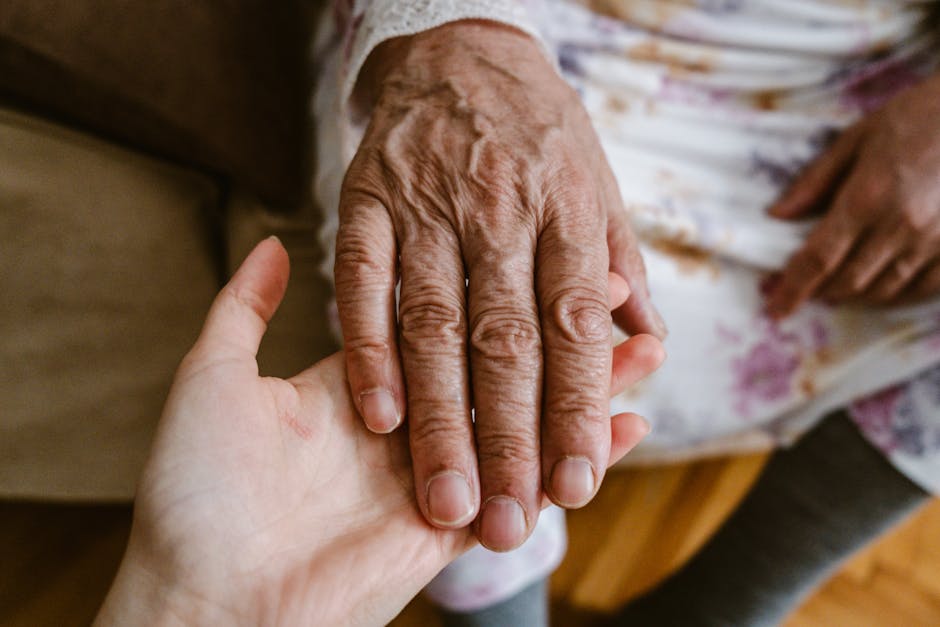 Hand of an elderly person symbolizing intention carried by others