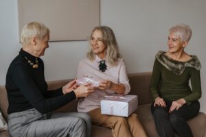 A family celebrating an elder's 60th birthday (kanreki) with gifts and warmth