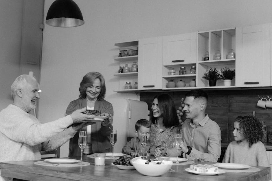 Family gathered at a dining table celebrating a parent's 60th birthday