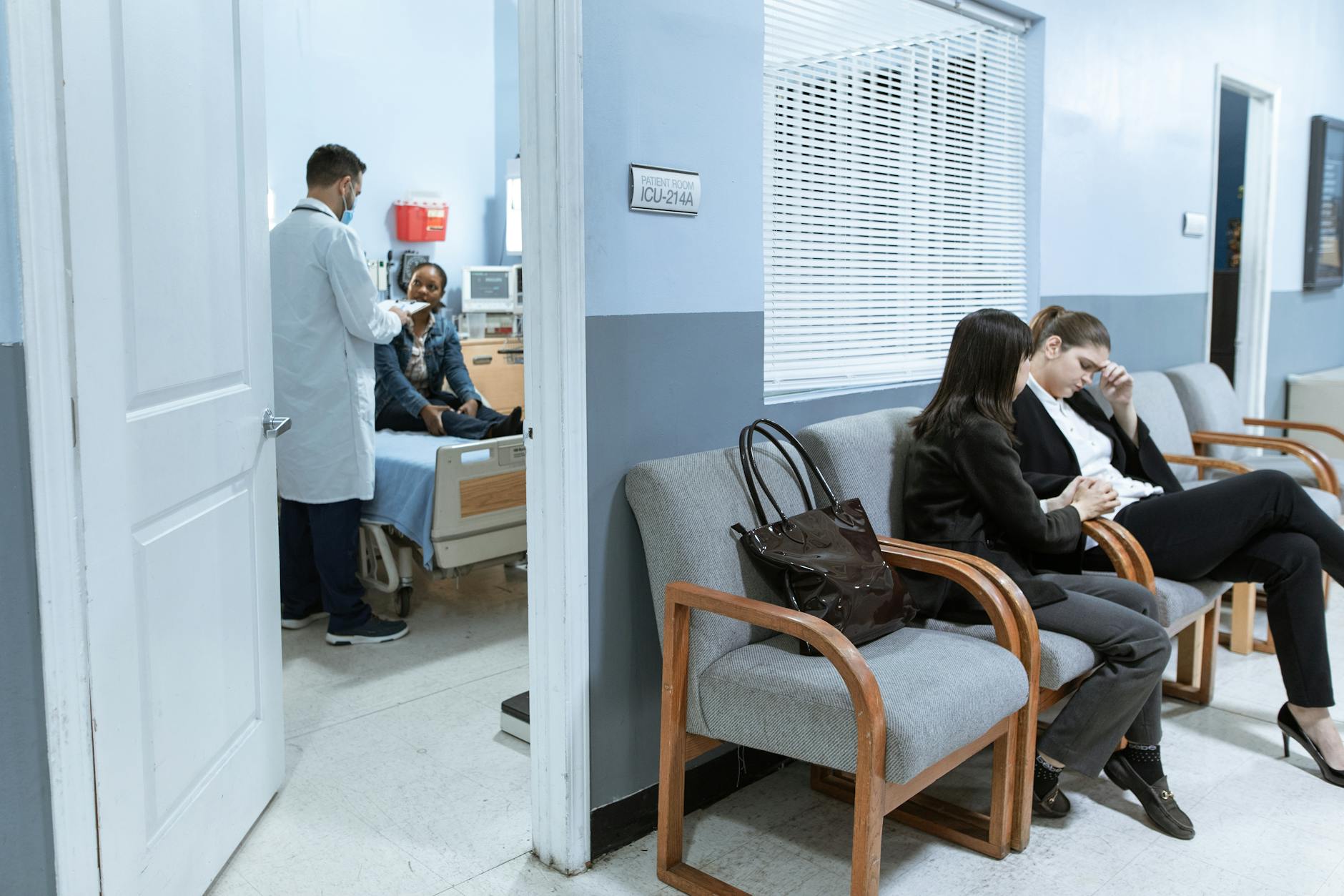 Family member quietly praying in a hospital corridor
