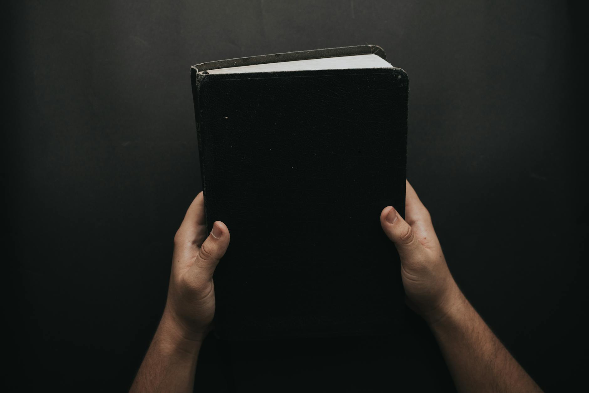 Holding a nokyocho book as a quiet act of hope for a loved one's recovery