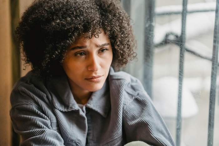 A quiet moment by a window — the helpless feeling of having a hospitalized family member far away
