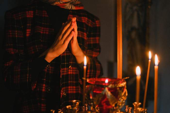 Hands holding a quiet prayer for a family member's recovery from far away