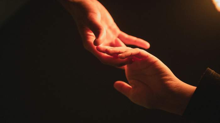 A warm hand reaching out, representing sending love to a hospitalized family member