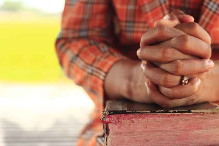 Quiet scene of using prayer to recenter when caregiving fatigue hits