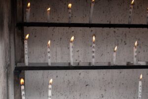 A quiet temple candle representing a proper Shikoku proxy pilgrimage for a yakudoshi year